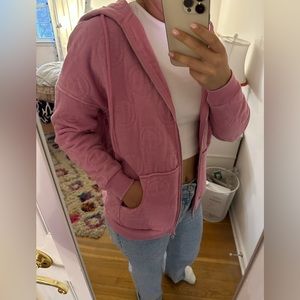 Pink smiley face sweatshirt.